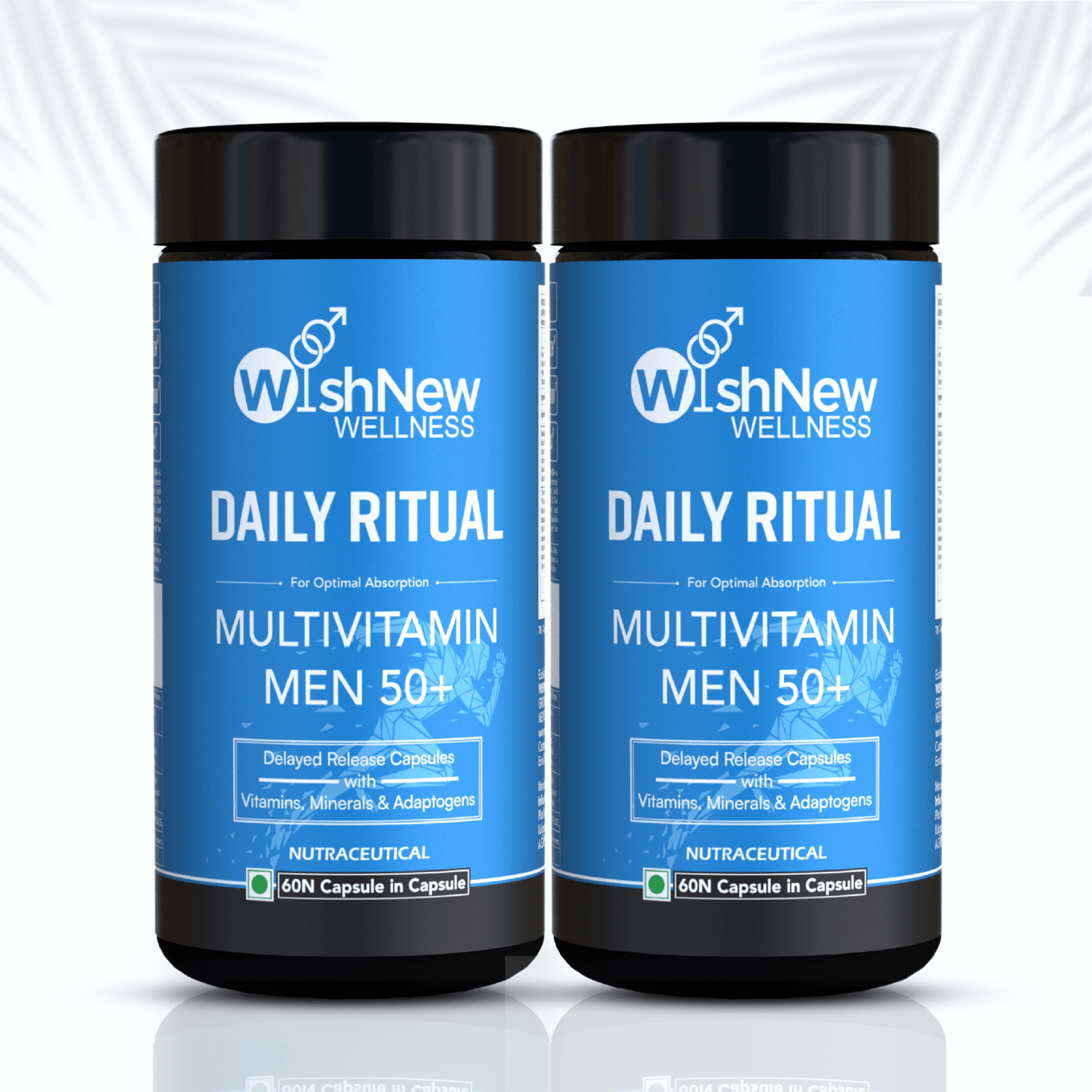 Image featuring two bottles of WishNew Wellness Daily Ritual Multivitamin Men 50+ placed side by side. The vibrant blue packaging emphasizes features such as delayed-release capsules with vitamins, minerals, and adaptogens. The clean white background with subtle palm leaf accents adds a natural and refreshing touch.